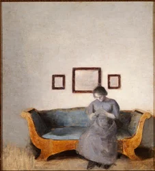 Ida Hammershoi auf einem Sofa sitzend